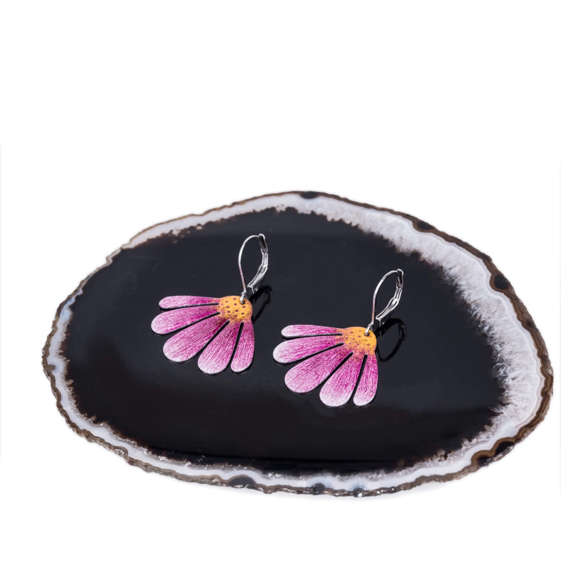 stylized photo of purple and pink echinacea earrings on a crystal