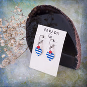 heart earrings with blue stripes and red coral beads  displayed on a branded Parada Jewelry gift card